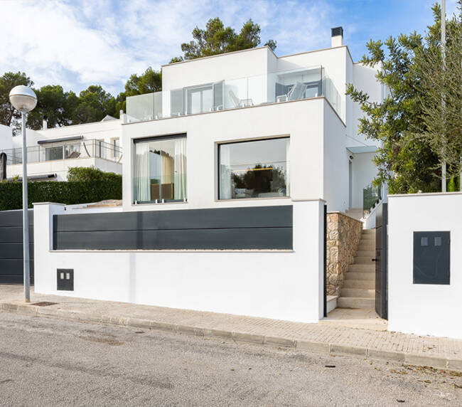 Interior of bright living room with brown and colorful pattern walls, wooden floor, comfortable brown sofa and round coffee table. Vertical mock up poster frame. 3d rendering